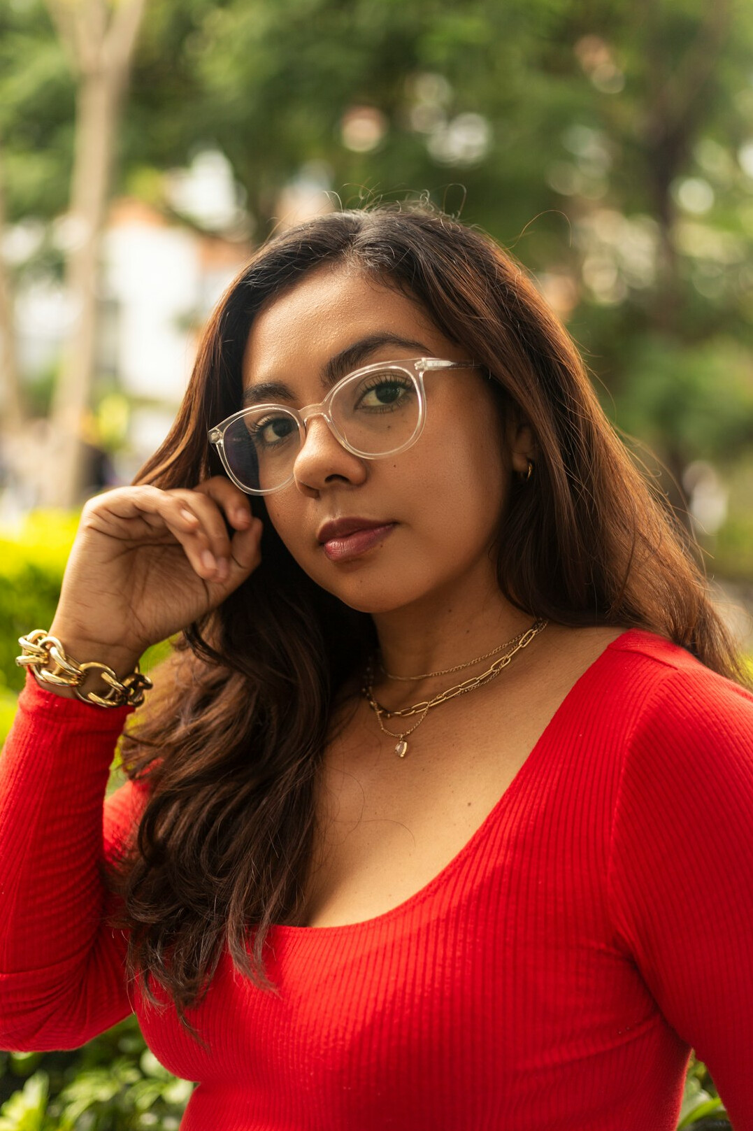 Portrait of a Latina woman in her 50s with short gray-streaked hair and glasses